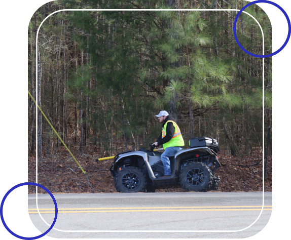 A man riding an atv on the side of a road.